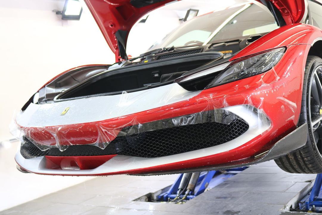 paint protection film (PPF) being used on red Ferrari at mile deep in Crewe