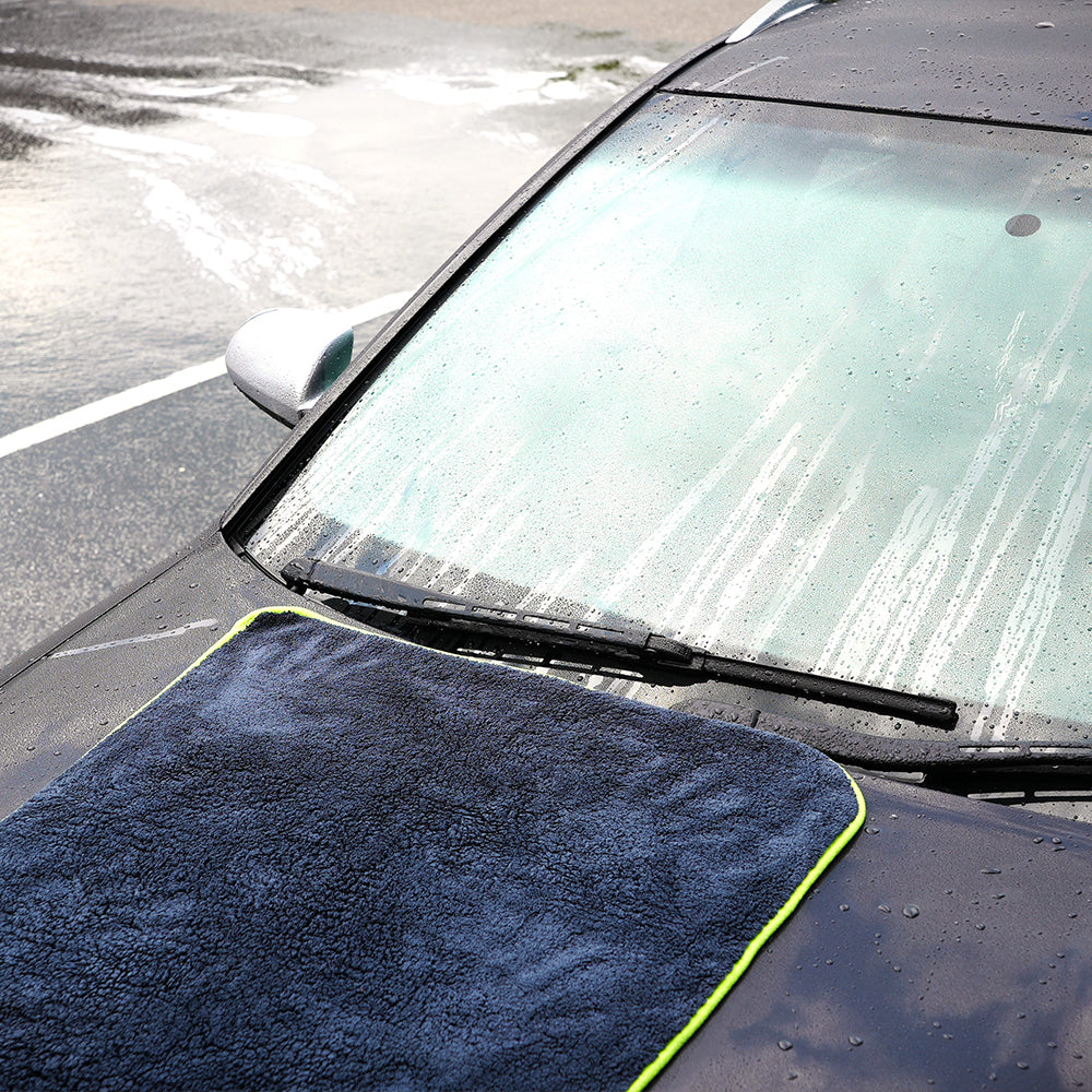 Absorb+ luxury car drying towel placed on black car