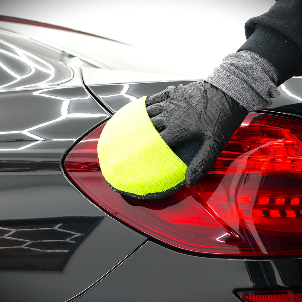 Apply microfibre applicator pad being used on car light