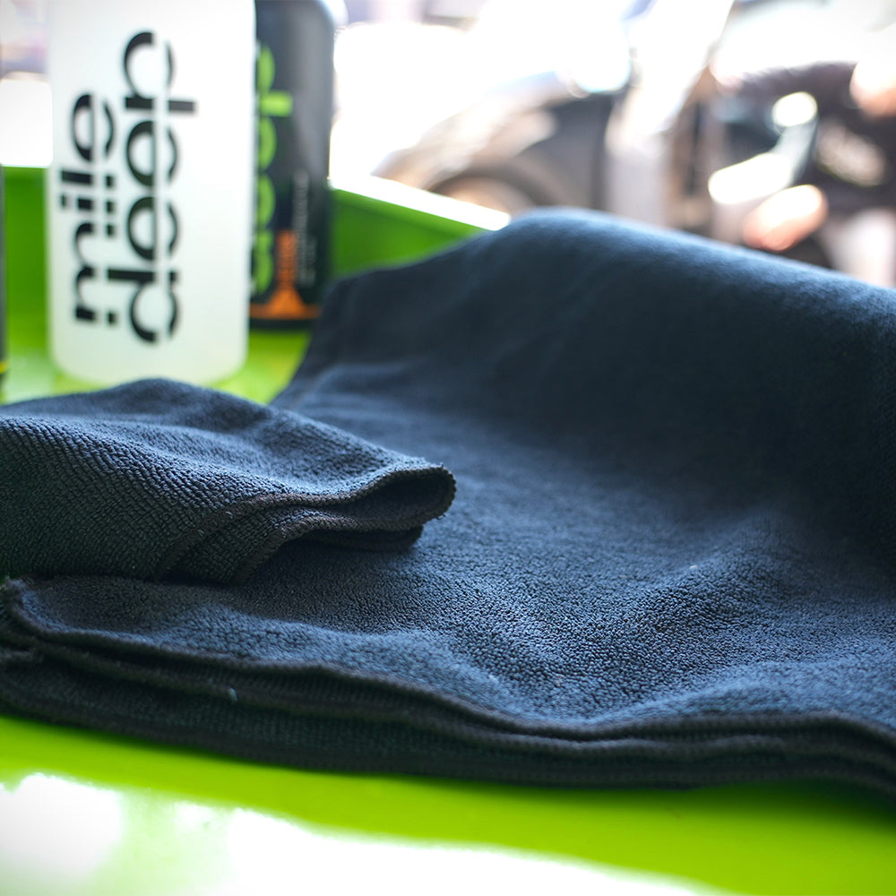 enact+ (pack of 10) 360 gsm microfibre car cloths on green work surface 