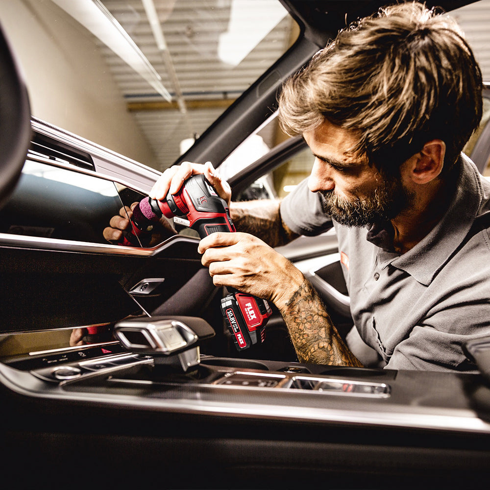 flex pxe 80 10.8-ec/2.5 set cordless machine polisher being used on a black car interior
