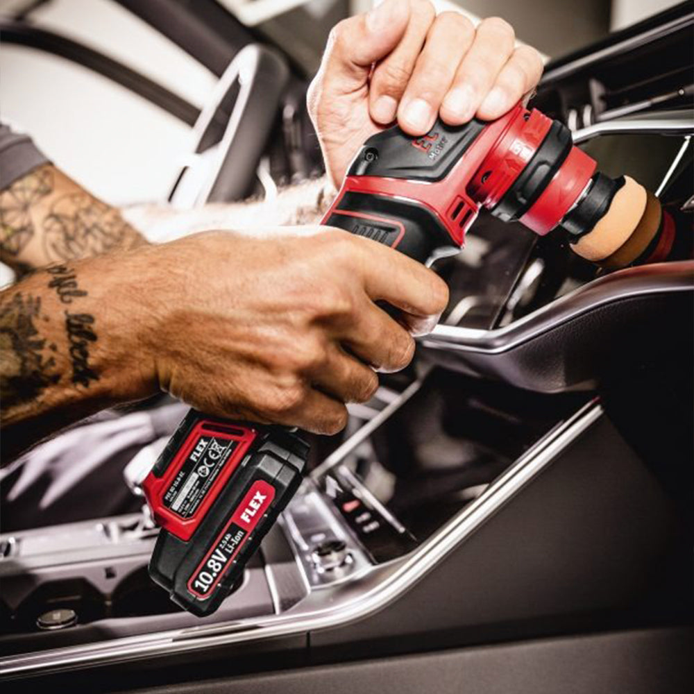 flex pxe 80 10.8-ec/2.5 set cordless machine polisher being used on a black car interior 