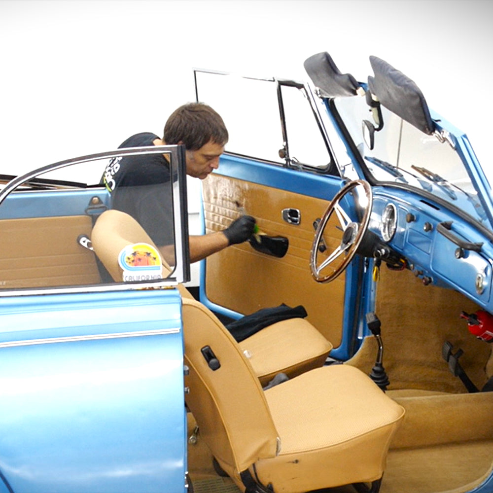 car interior kit being used to clean interior of blue car 