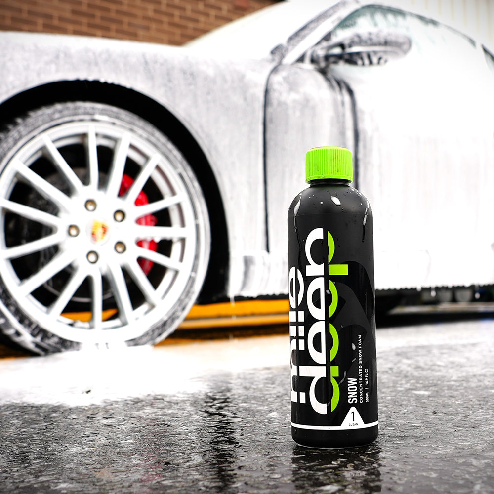 SNOW concentrated snow foam car pre-wash product beside porsche vehicle
