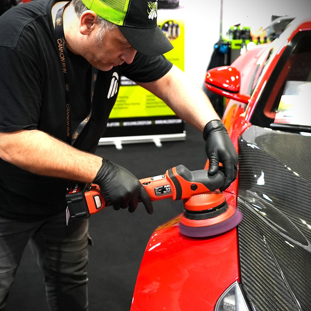 cordless machine polishing red car at mile deep in Crewe